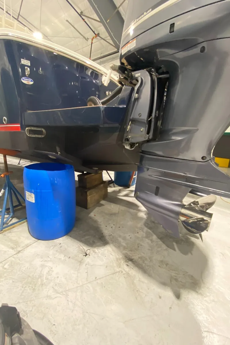 Slide: The Image of 2015 Regulator 34 Center Console boat in a garage, showing the outboard motor. - 35