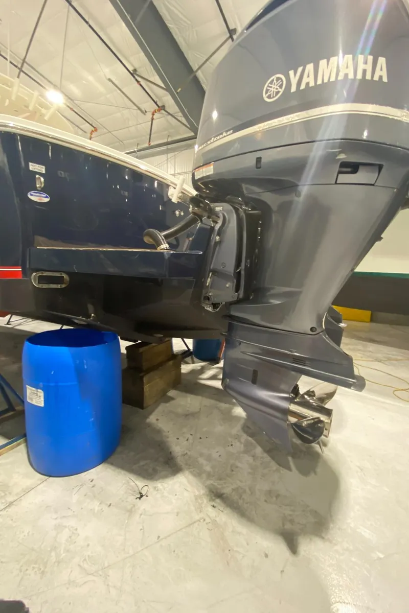 Slide: The Image of 2015 Regulator 34 Center Console with Yamaha outboard motor in a garage setting. - 36
