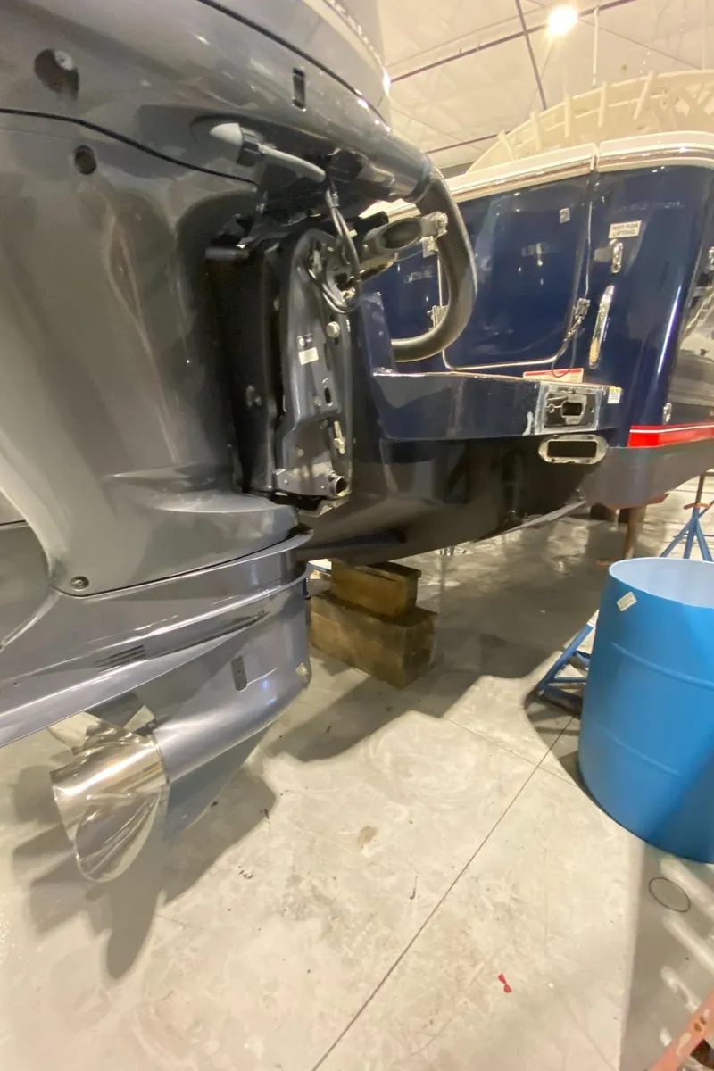 Slide: The Image of 2015 Regulator 34 Center Console boat in storage, showing engine and hull details. - 37