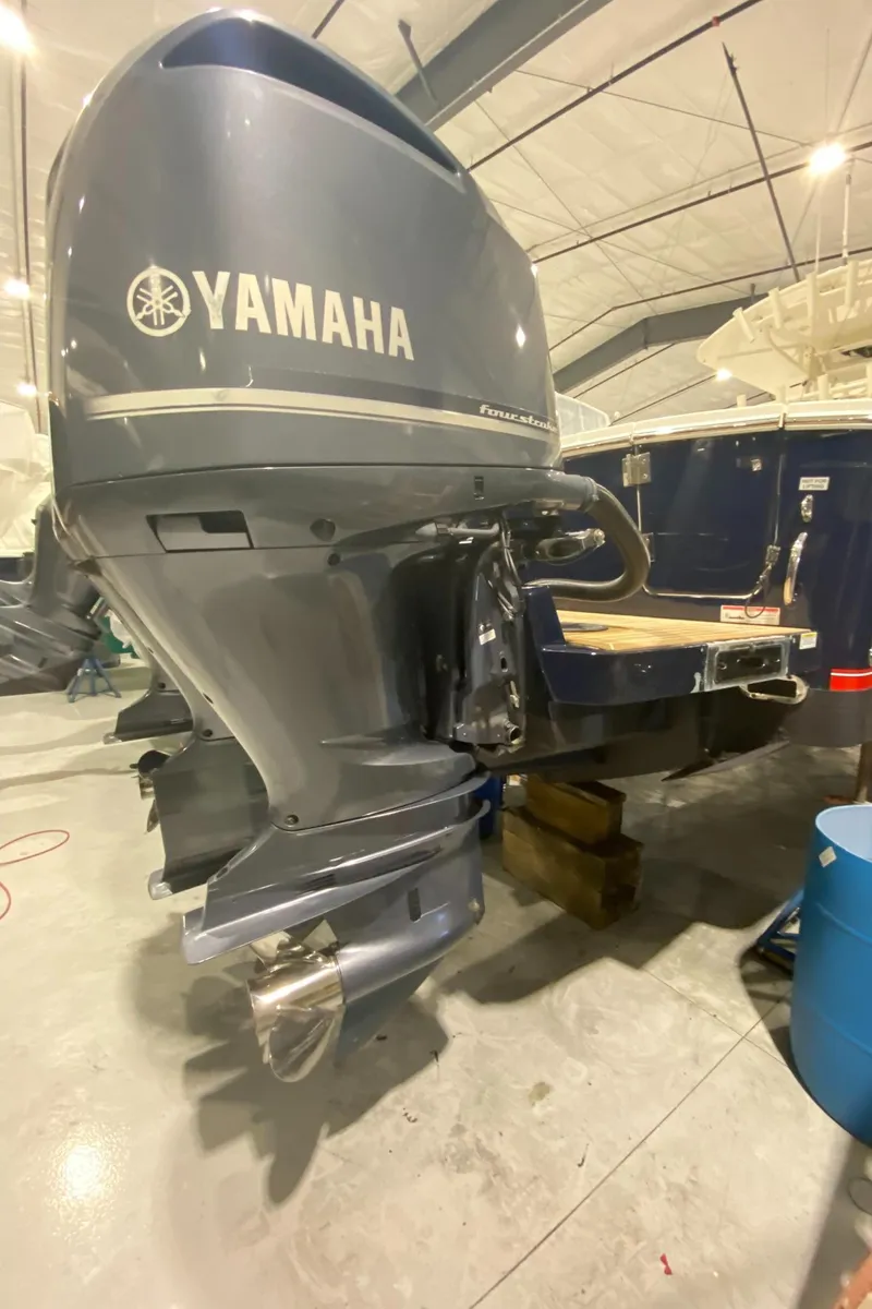 Slide: The Image of 2015 Regulator 34 Center Console with Yamaha outboard motor in a workshop setting. - 38
