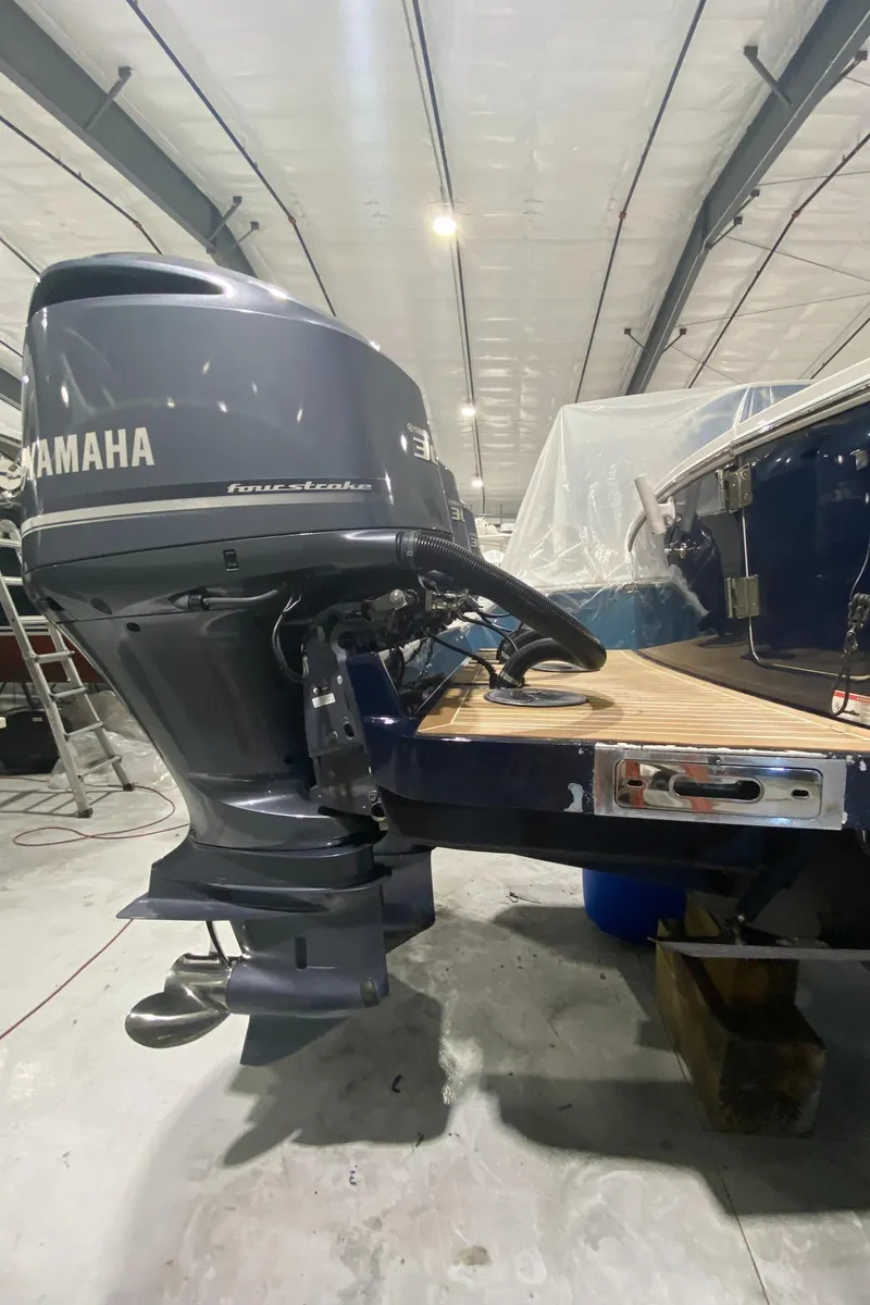 Slide: The Image of 2015 Regulator 34 Center Console with Yamaha outboard motor in a storage facility. - 39