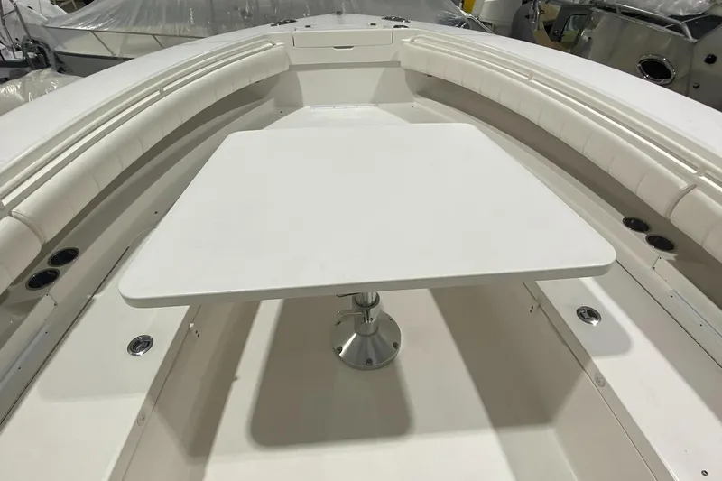 Slide: The Image of 2015 Regulator 34 Center Console boat interior with table and seating. - 4