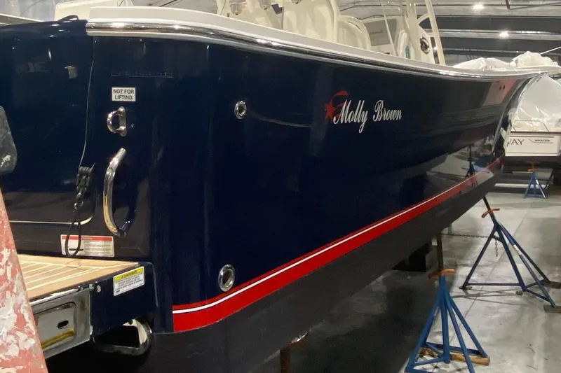 Slide: The Image of 2015 Regulator 34 Center Console boat in storage, named "Molly Brown." - 47