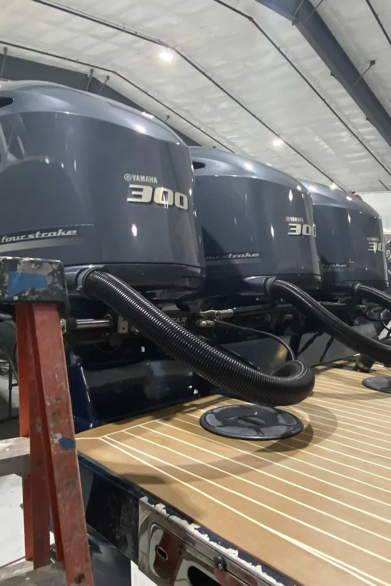 Slide: The Image of 2015 Regulator 34 Center Console with Yamaha 300 outboard engines in a boatyard. - 48