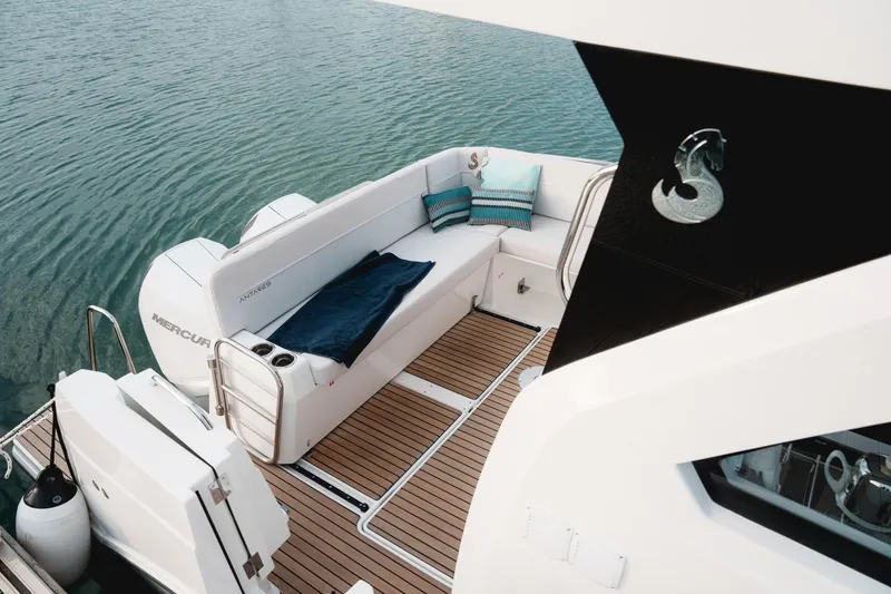 Slide: The Image of 2025 Beneteau Antares 9 boat deck with seating, cushions, and Mercury engine. - 16
