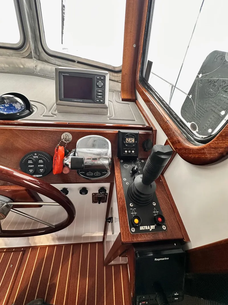 Slide: The Image of Control panel of 2009 New England Boatworks Hunt 35 with joystick and navigation equipment. - 12