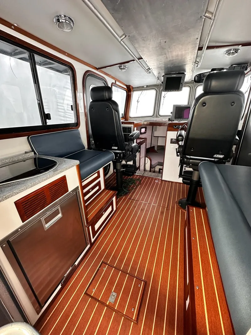 Slide: The Image of Interior of 2009 New England Boatworks Hunt 35 with sleek seating and wood flooring. - 15