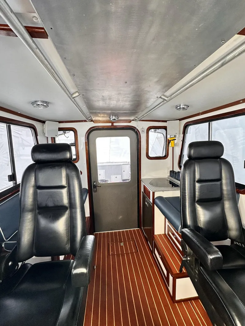 Slide: The Image of Interior of 2009 New England Boatworks Hunt 35 with leather seats and wood flooring. - 16