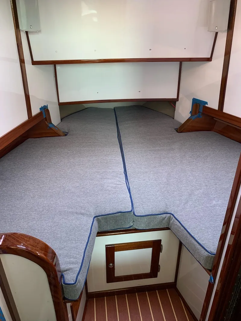Slide: The Image of 2009 New England Boatworks Hunt 35 cabin interior with V-berth and wooden accents. - 3