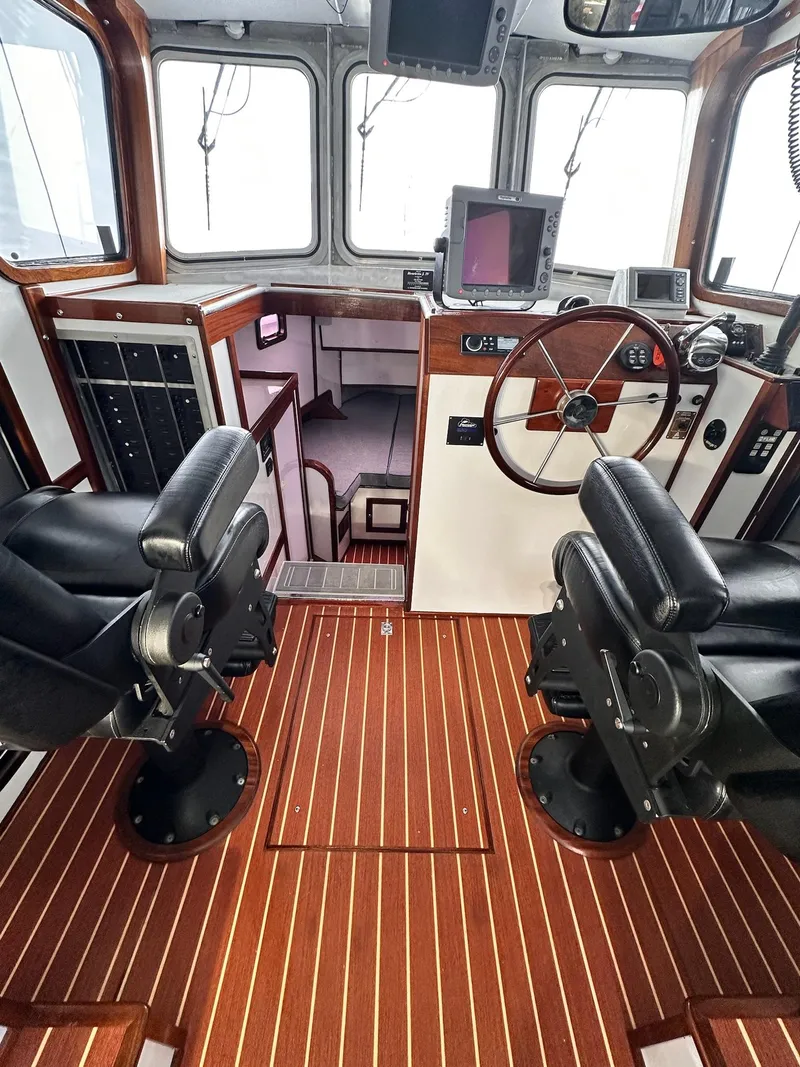 Slide: The Image of 2009 New England Boatworks Hunt 35 cockpit with wood flooring and modern navigation equipment. - 4
