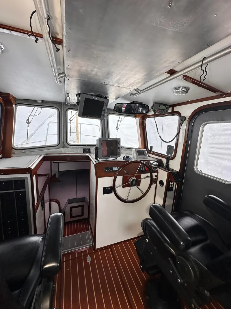 Slide: The Image of Interior of 2009 New England Boatworks Hunt 35, featuring helm and navigation equipment. - 6