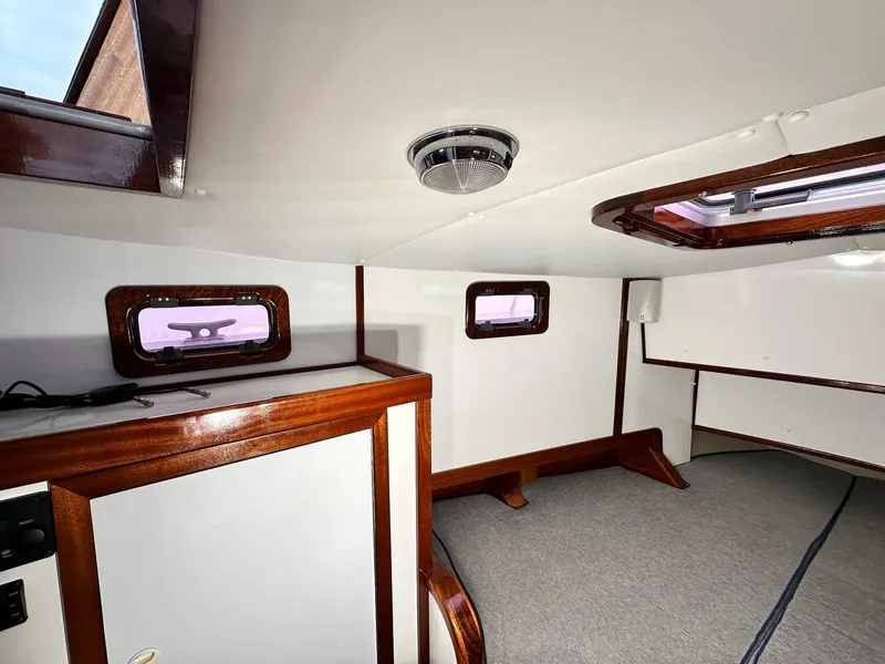 Slide: The Image of Interior cabin of 2009 New England Boatworks Hunt 35 with wood accents and windows. - 8