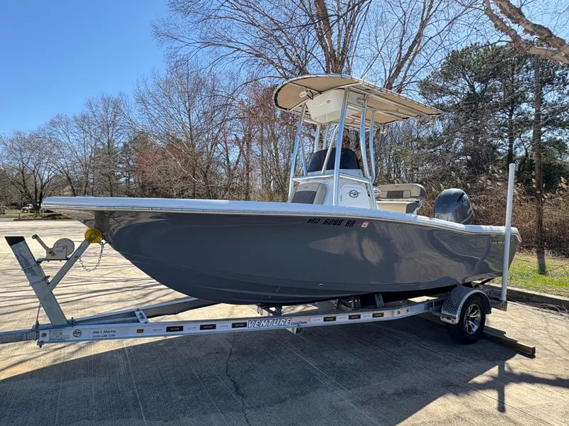 Slide: The Image of 2022 Tidewater 198 CC Adventure boat on trailer, parked outdoors. - 11