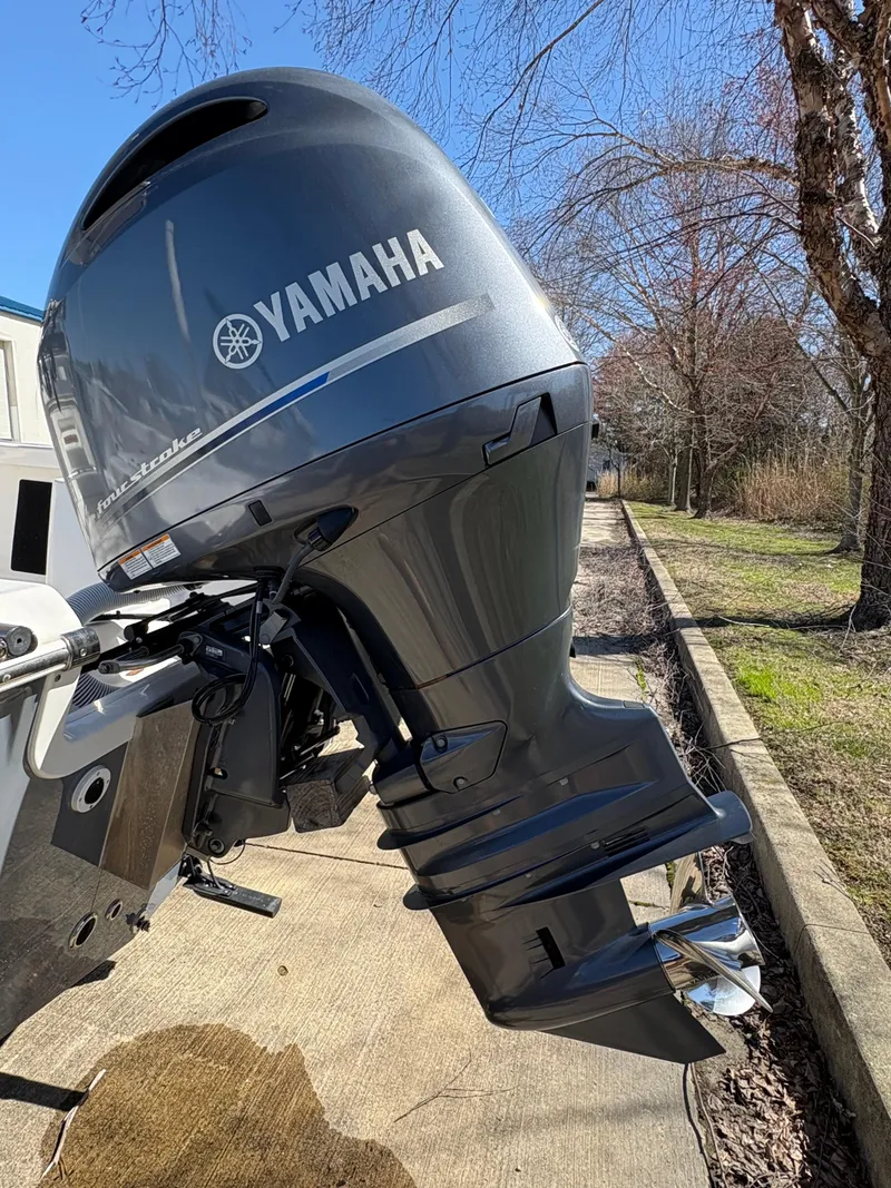 Slide: The Image of 2022 Tidewater 198 CC Adventure with Yamaha outboard motor, parked on a sunny day. - 12