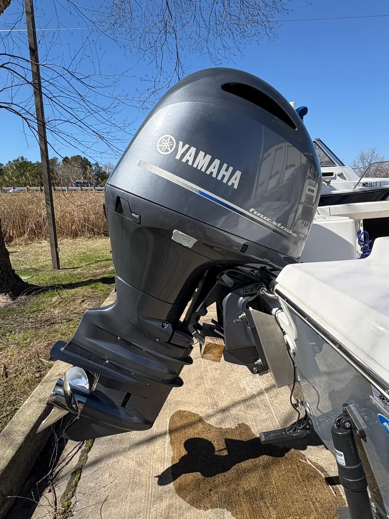 Slide: The Image of 2022 Tidewater 198 CC Adventure with Yamaha outboard motor, parked outdoors. - 13