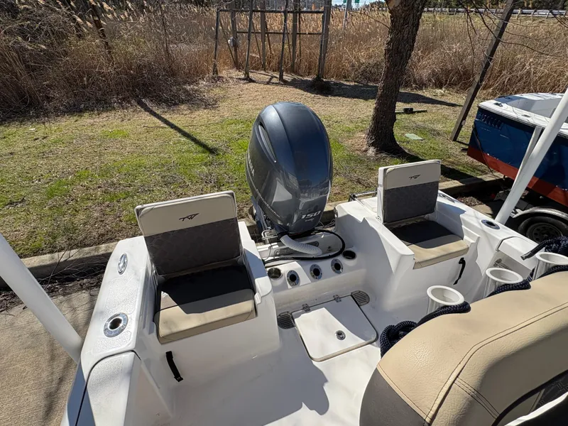 Slide: The Image of 2022 Tidewater 198 CC Adventure boat with Yamaha outboard motor, docked outdoors. - 17