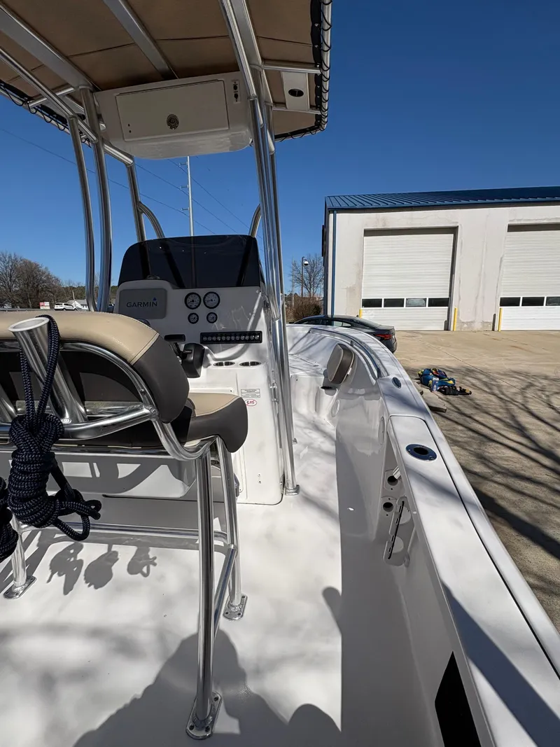 Slide: The Image of 2022 Tidewater 198 CC Adventure boat with console and seating, parked outdoors. - 19