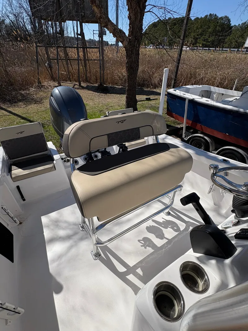 Slide: The Image of 2022 Tidewater 198 CC Adventure boat interior with seating and controls. - 20