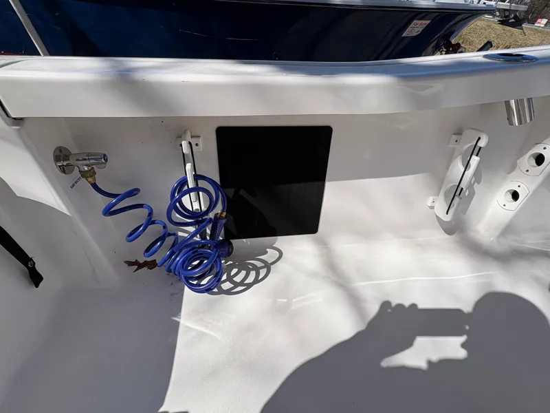 Slide: The Image of 2022 Tidewater 198 CC Adventure boat deck with coiled blue hose and fittings. - 21
