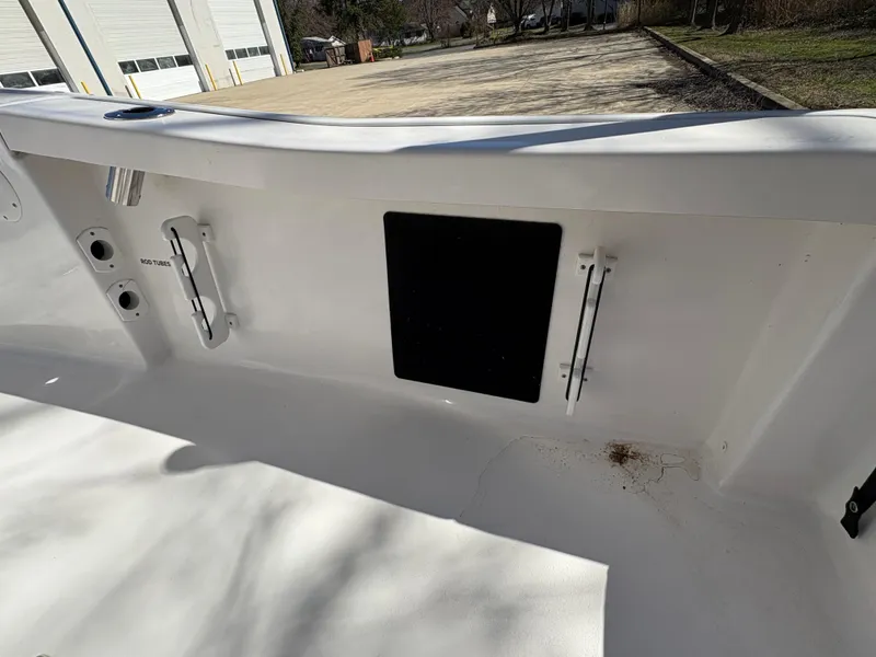 Slide: The Image of 2022 Tidewater 198 CC Adventure boat interior with rod holders and storage compartment. - 22