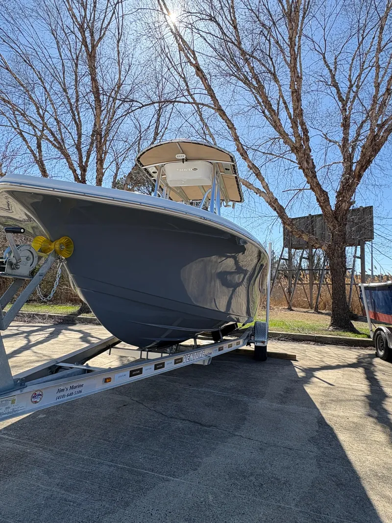 Slide: The Image of 2022 Tidewater 198 CC Adventure boat on trailer under clear blue sky. - 3