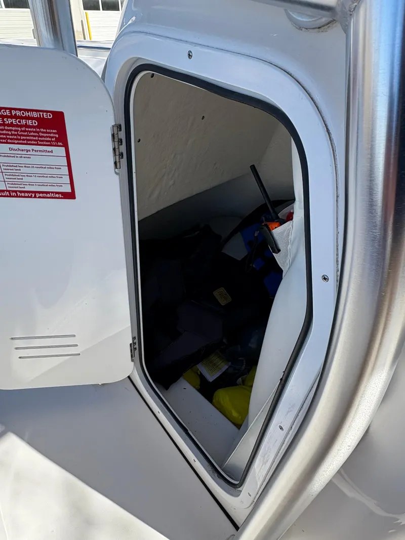 Slide: The Image of Storage compartment on a 2022 Tidewater 198 CC Adventure boat, partially open. - 30