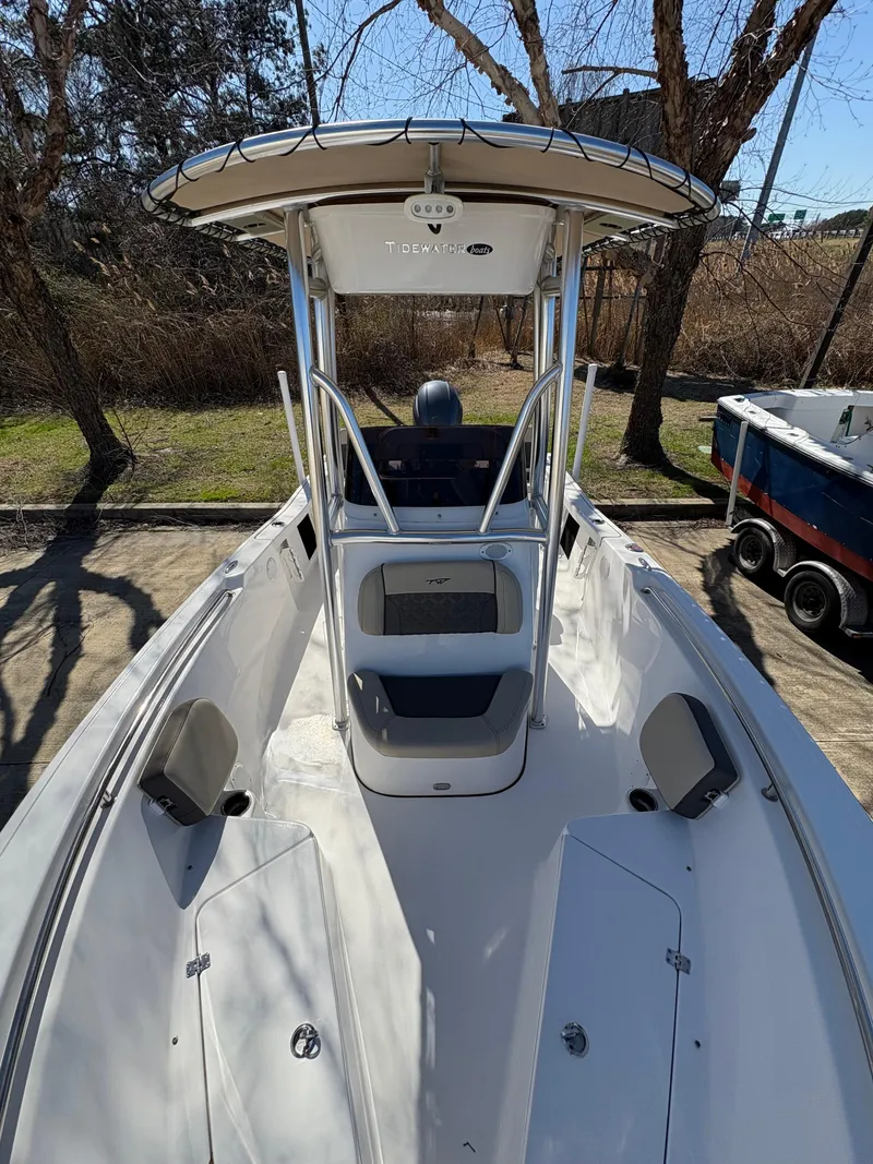 Slide: The Image of 2022 Tidewater 198 CC Adventure boat with T-top, parked outdoors. - 33