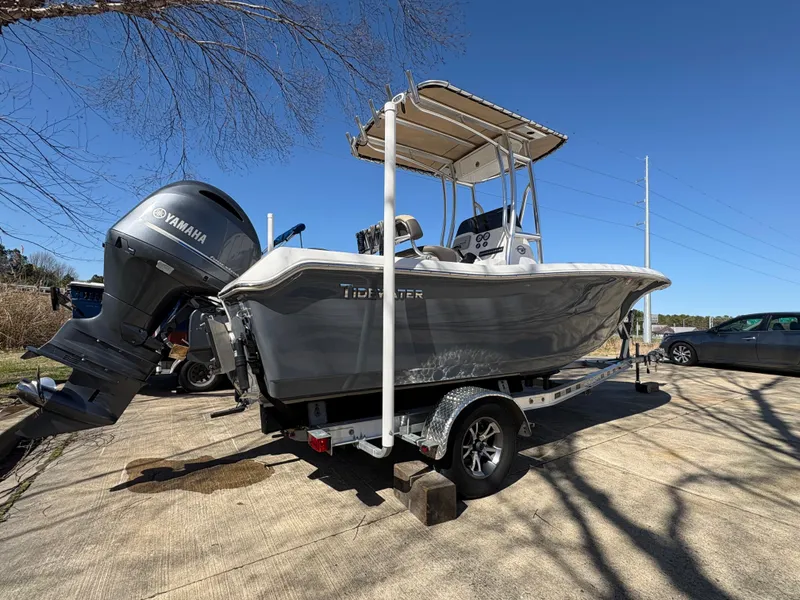 Slide: The Image of 2022 Tidewater 198 CC Adventure boat on trailer with Yamaha engine, parked outdoors. - 7