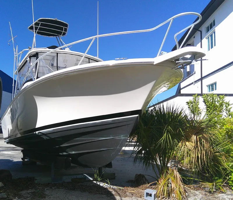 Slide: The Image of 2000 Luhrs Tournament 290 Open boat on display, surrounded by greenery. - 12