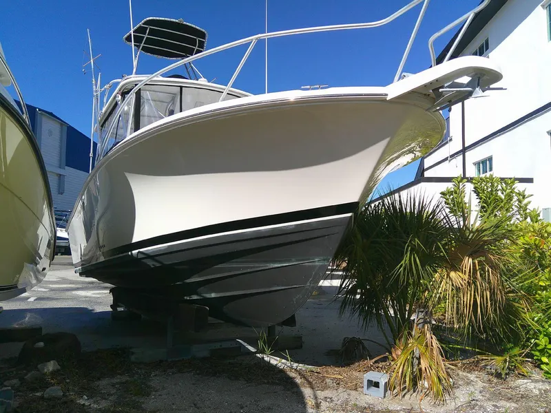 Slide: The Image of 2000 Luhrs Tournament 290 Open boat on dry dock, surrounded by tropical plants. - 13