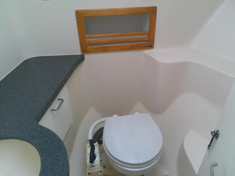 Slide: The Image of Bathroom interior of 2000 Luhrs Tournament 290 Open boat, featuring toilet and countertop. - 25