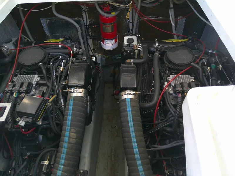 Slide: The Image of Engine compartment of 2000 Luhrs Tournament 290 Open boat, featuring dual engines and fire extinguisher. - 27