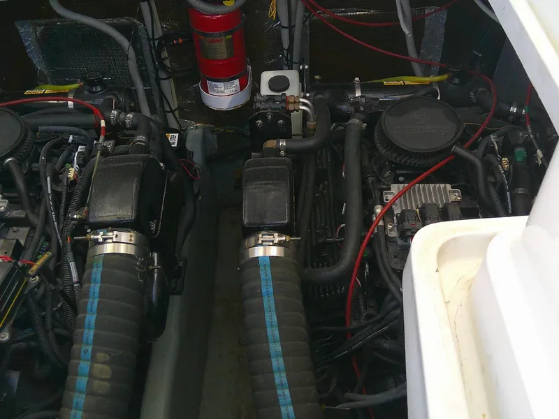 Slide: The Image of Engine compartment of a 2000 Luhrs Tournament 290 Open boat, featuring dual engines and fire extinguisher. - 29