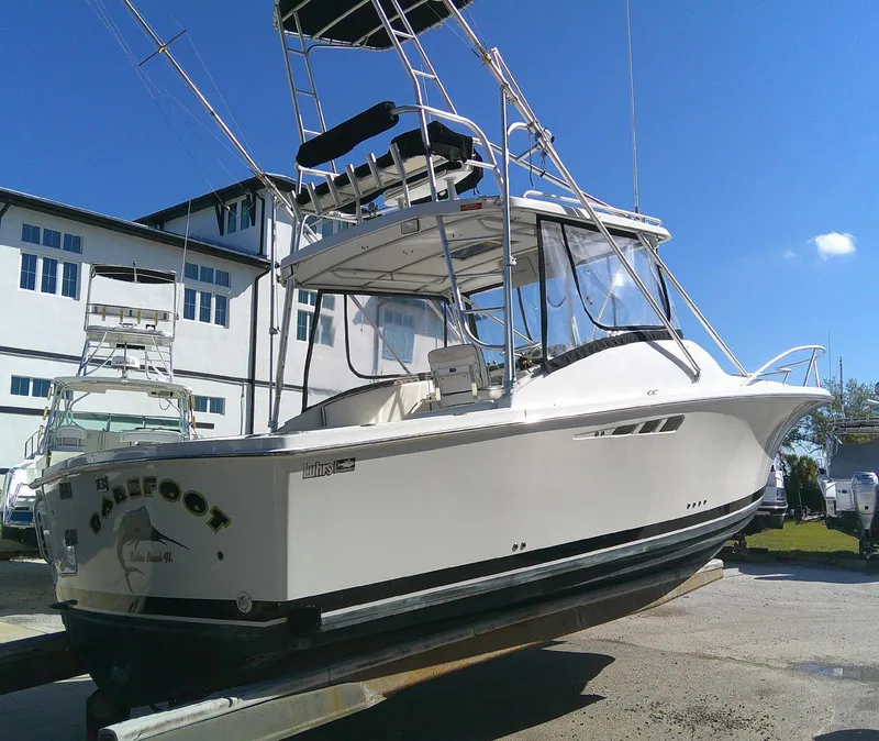 Slide: The Image of 2000 Luhrs Tournament 290 Open boat on display, featuring sleek design and tower. - 6