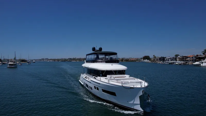 Slide: The Image of 2023 Sirena 68 yacht cruising on a sunny day in a marina. - 1