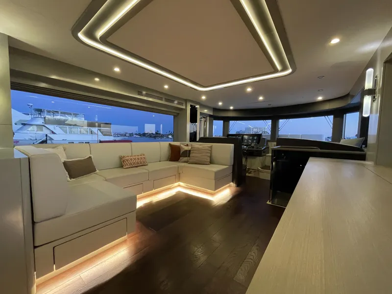 Slide: The Image of Luxurious interior of 2023 Sirena 68 yacht with modern lighting and spacious seating. - 11
