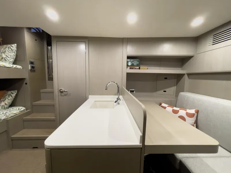 Slide: The Image of Modern interior of 2023 Sirena 68 yacht with kitchenette, seating, and bunk beds. - 17