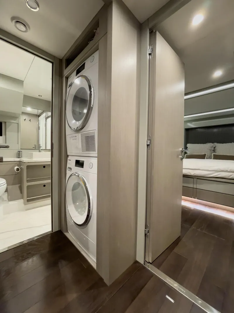 Slide: The Image of 2023 Sirena 68 yacht interior with stacked washer and dryer, modern bathroom, and bedroom. - 20
