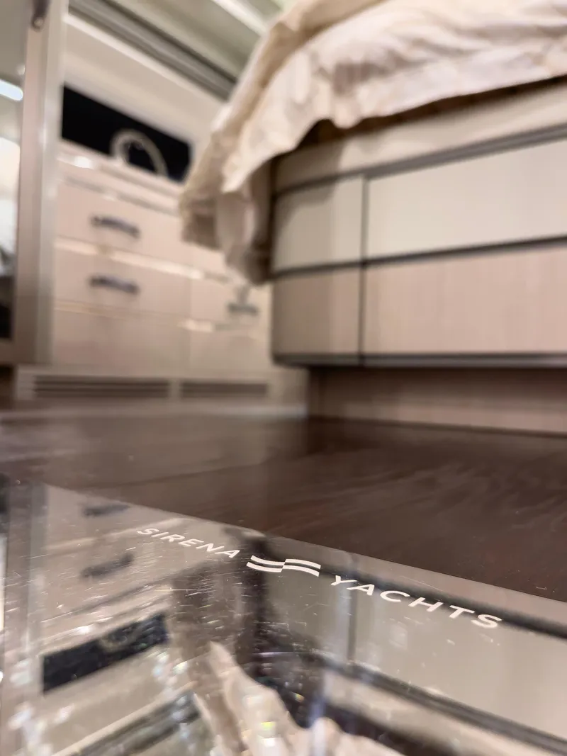 Slide: The Image of Interior of 2023 Sirena 68 yacht, featuring elegant wood flooring and modern furnishings. - 25