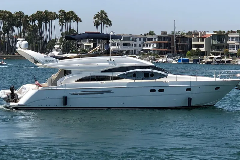The Image of 2006 Viking Princess 61 Flybridge yacht cruising near waterfront homes and palm trees. - 0