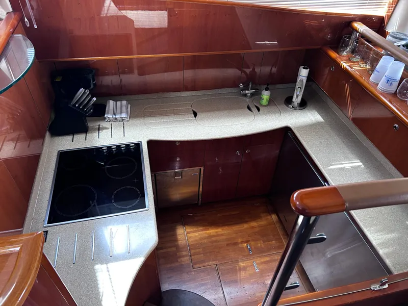 Slide: The Image of Luxurious kitchen area in a 2006 Viking Princess 61 Flybridge yacht, featuring modern appliances. - 19