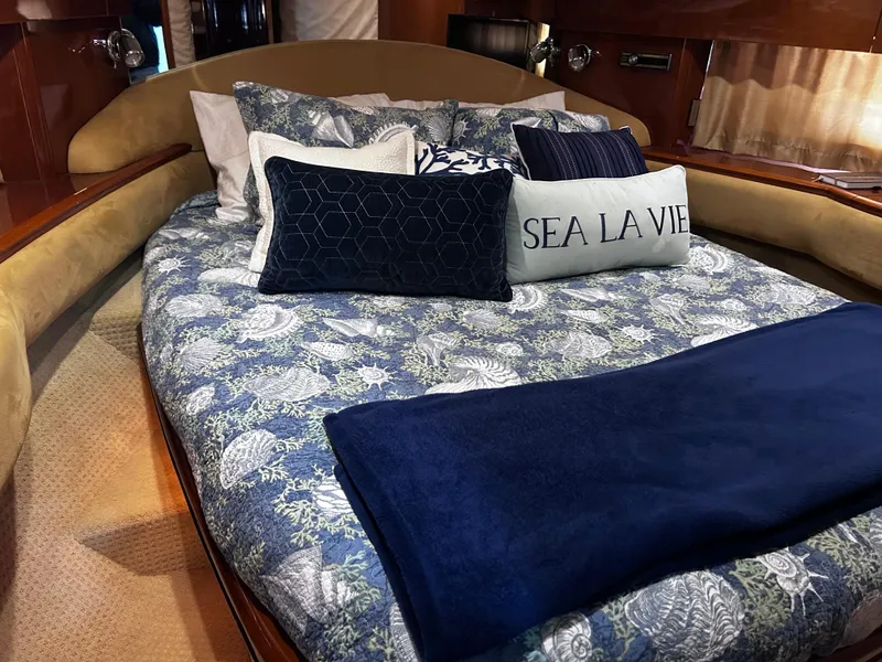 Slide: The Image of Luxurious bedroom in 2006 Viking Princess 61 Flybridge yacht with elegant bedding and cushions. - 25