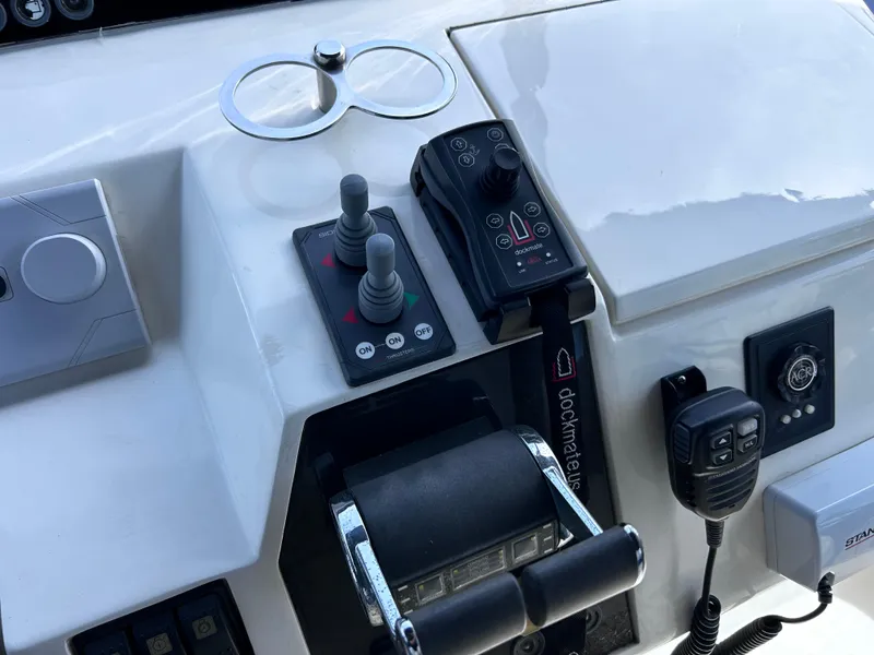 Slide: The Image of Control panel of 2006 Viking Princess 61 Flybridge yacht with joystick and communication devices. - 31