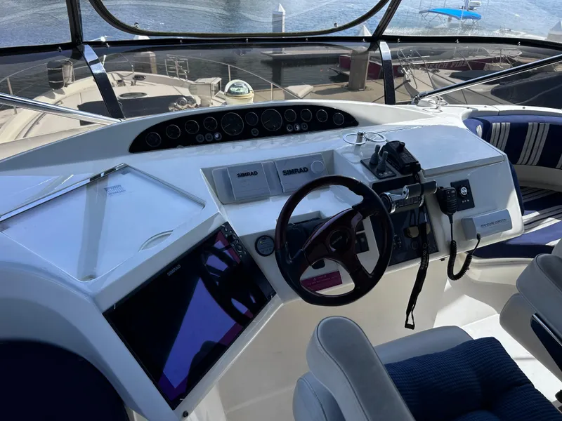 Slide: The Image of Helm of 2006 Viking Princess 61 Flybridge yacht with navigation controls and steering wheel. - 33