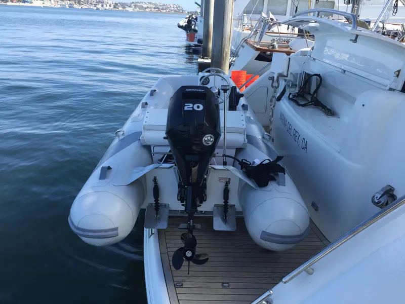 Slide: The Image of 2006 Viking Princess 61 Flybridge yacht with attached inflatable boat and outboard motor. - 5