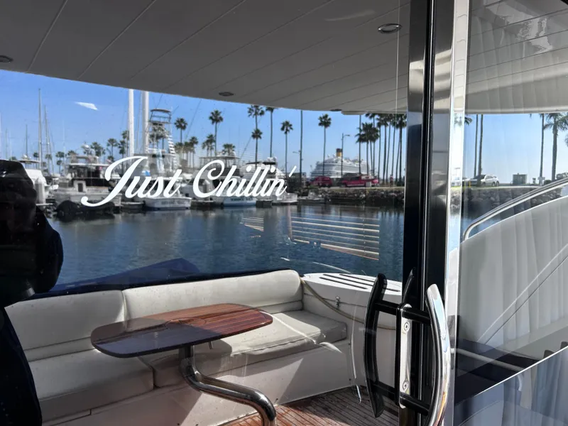 Slide: The Image of Viking Princess 61 Flybridge yacht, 2006, with "Just Chillin'" text, docked at marina. - 9