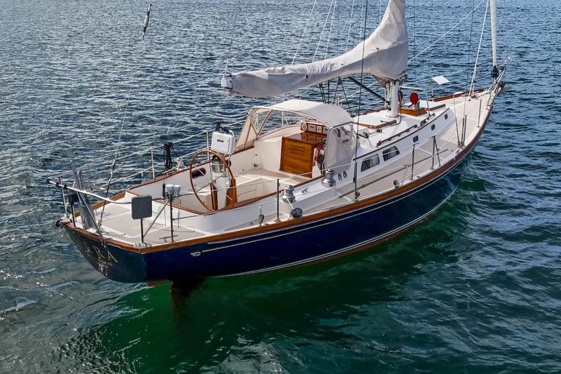 Slide: The Image of Hinckley Sou'wester 42 Sloop, 1994, sailing on calm waters with white sails. - 2