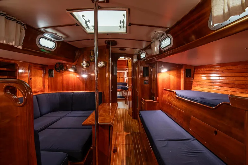 Slide: The Image of Interior of 1994 Hinckley Sou'wester 42 Sloop with wooden finish and blue seating. - 25