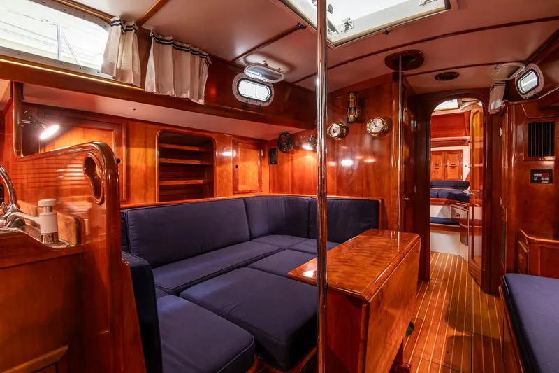 Slide: The Image of Luxurious 1994 Hinckley Sou'wester 42 Sloop interior with rich wood finish and blue seating. - 31