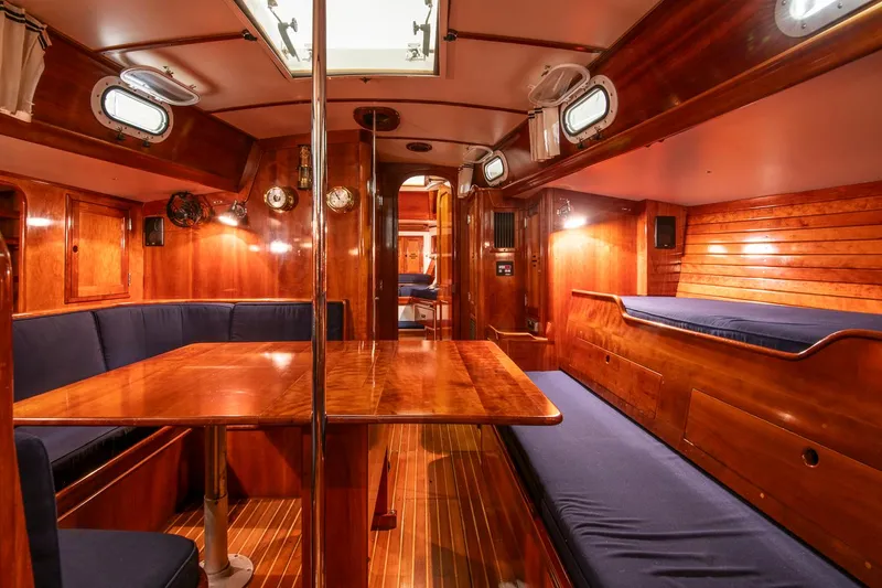 Slide: The Image of Interior of 1994 Hinckley Sou'wester 42 Sloop, featuring polished wood and blue seating. - 34